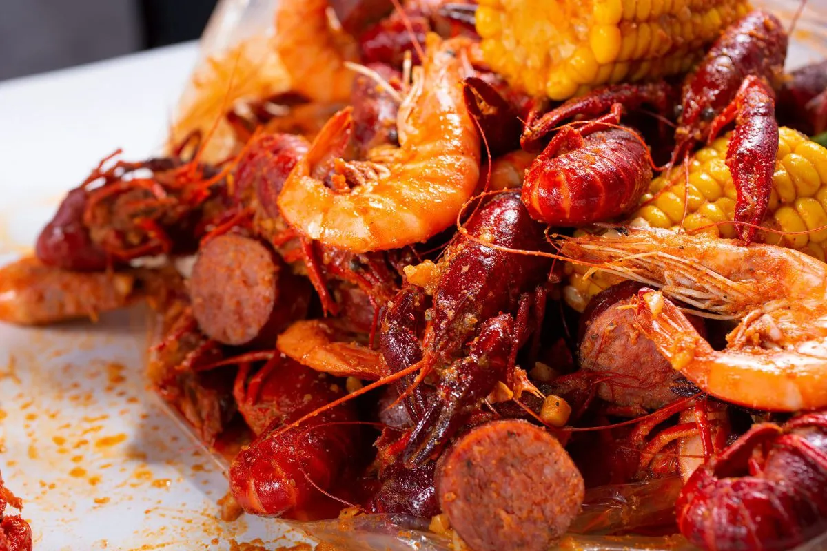 Crawfish, shrimp, sausage and corn coated in Cajun seasoning